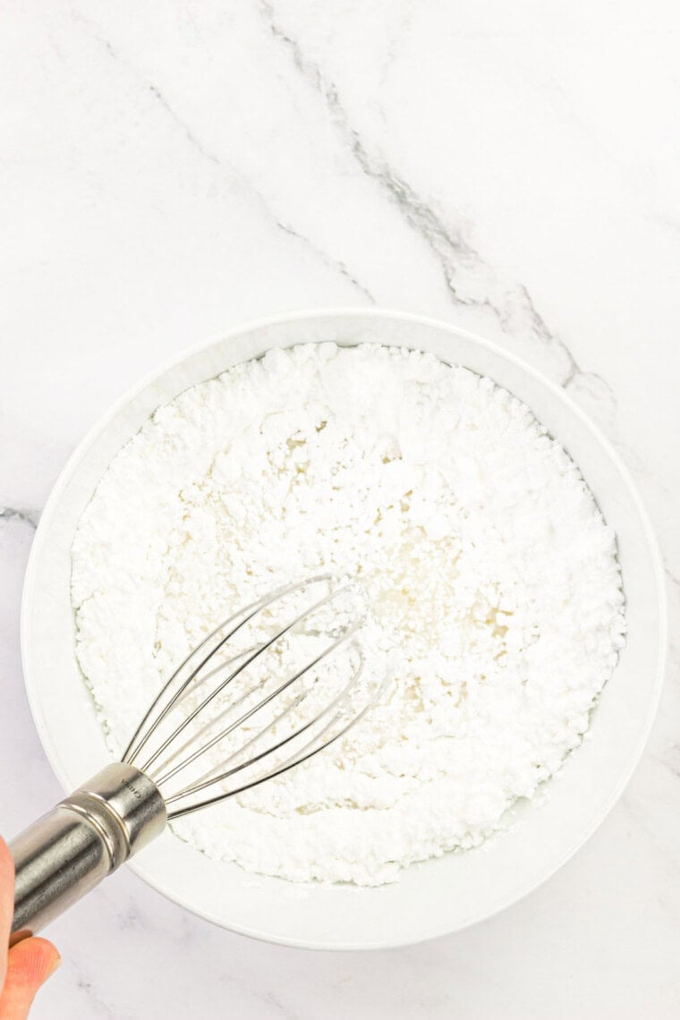 Whisking in the powdered sugar for the glaze.