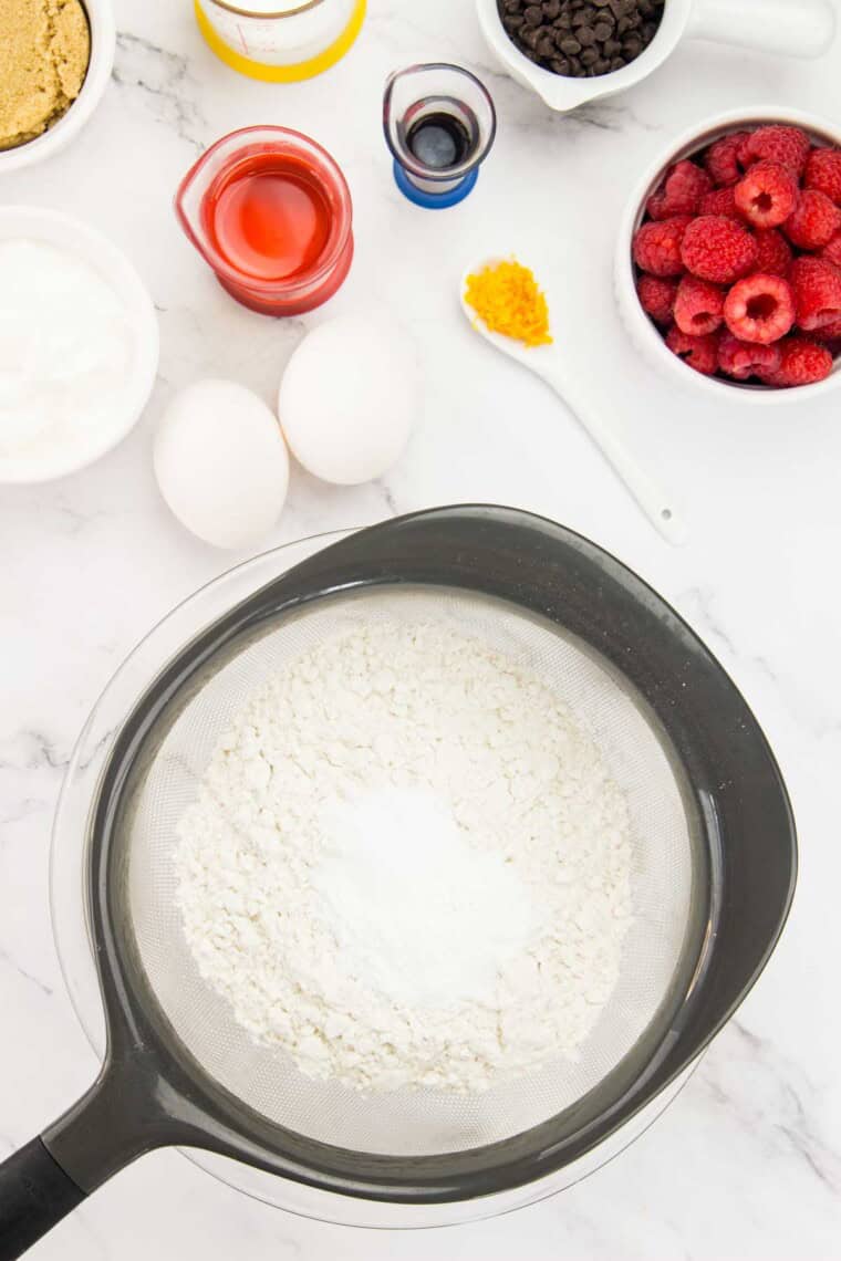 The gluten free flour is sifted into a bowl.