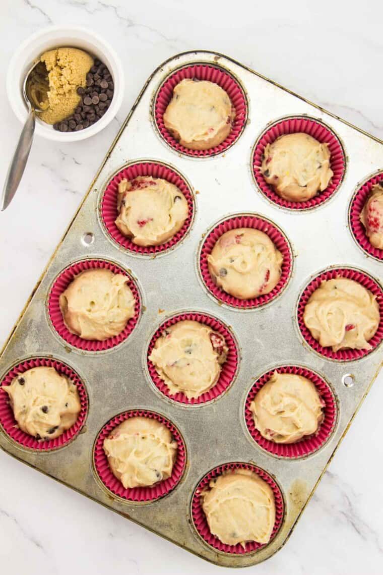 The muffin batter is portioned into the lined tin.