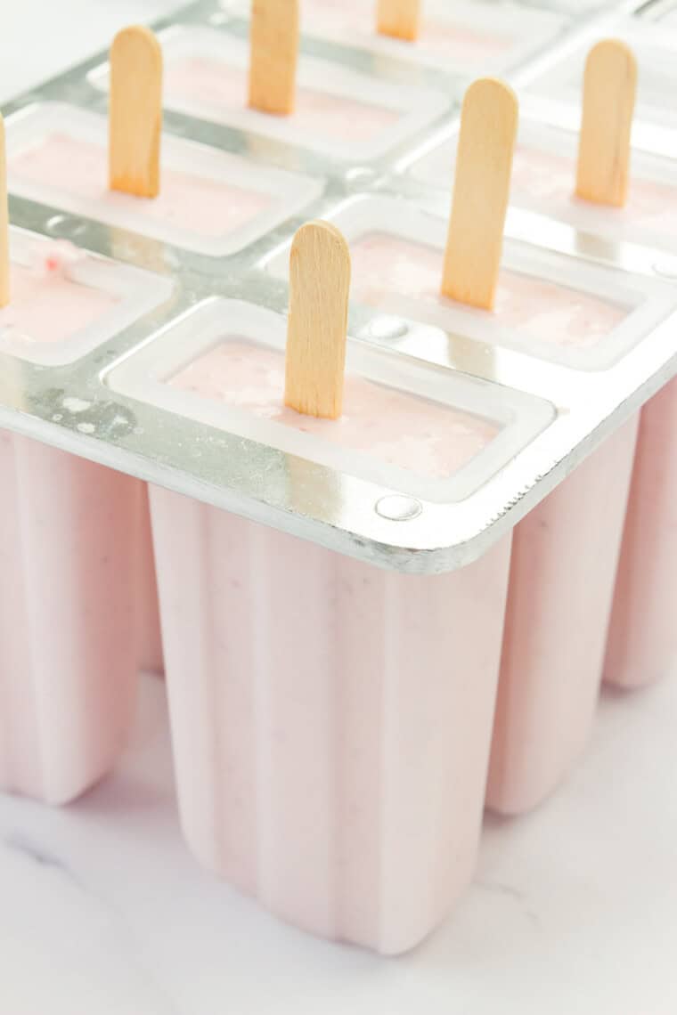 The popsicles in the mold before being frozen.