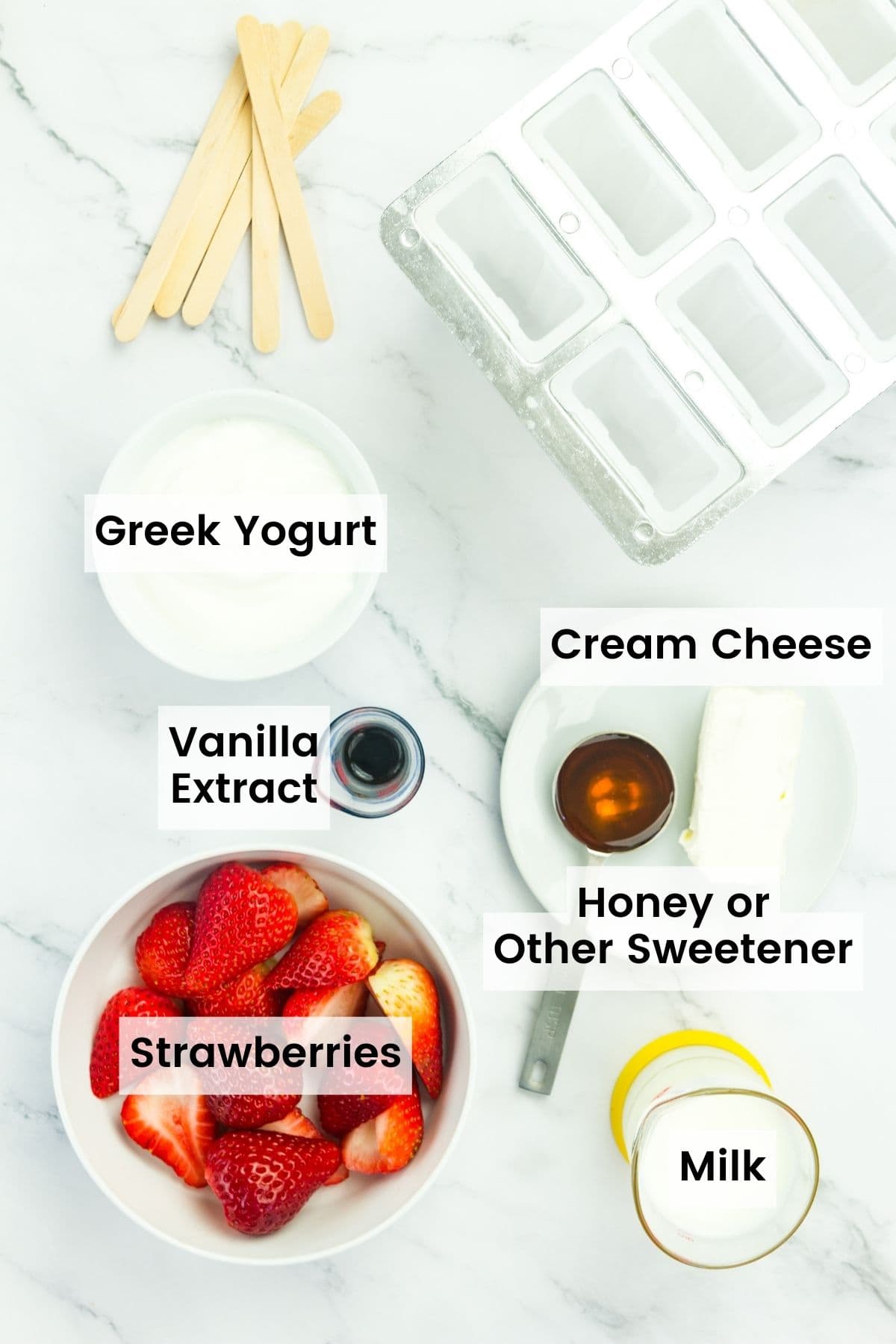 The ingredients to make strawberry popsicle with text labels including Greek yogurt, cream cheese, vanilla extract, honey, milk, and strawberries, plus popsicle sticks and a mold.