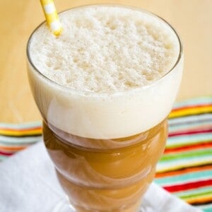 A frothy blended iced coffee in a glass.