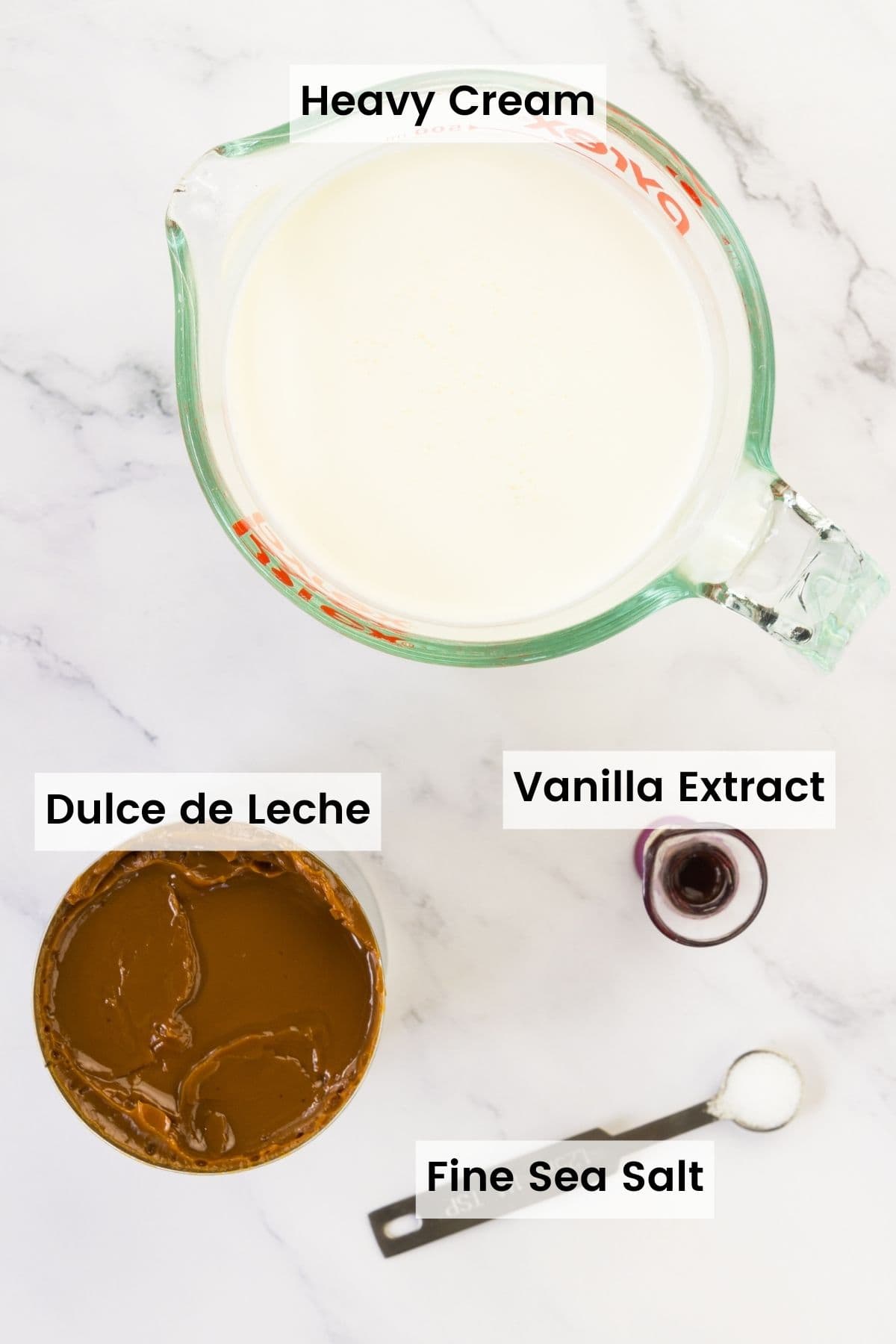 Ingredients for dulce de leche ice cream are portioned and labeled: dulce de leche, vanilla, heavy cream, sea salt.