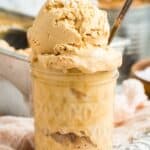 Scoops of ice cream in a glass jar with a spoon with text overlay that says "Dulce de Leche No-Churn Ice Cream".