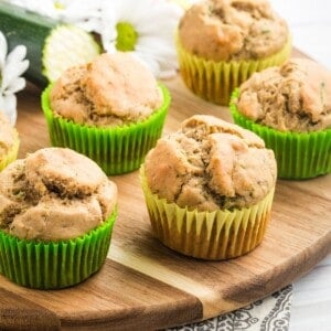 Banana Zucchini Muffins on a wooden platter.