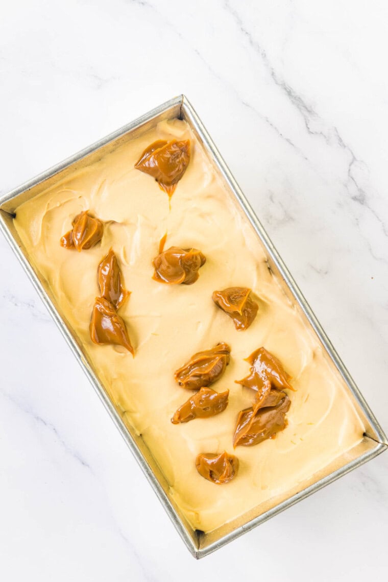 Dulce de leche is dolloped on top of the ice cream base.