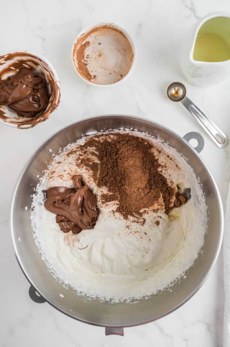 Ingredients for nutella ice cream are added to a bowl.