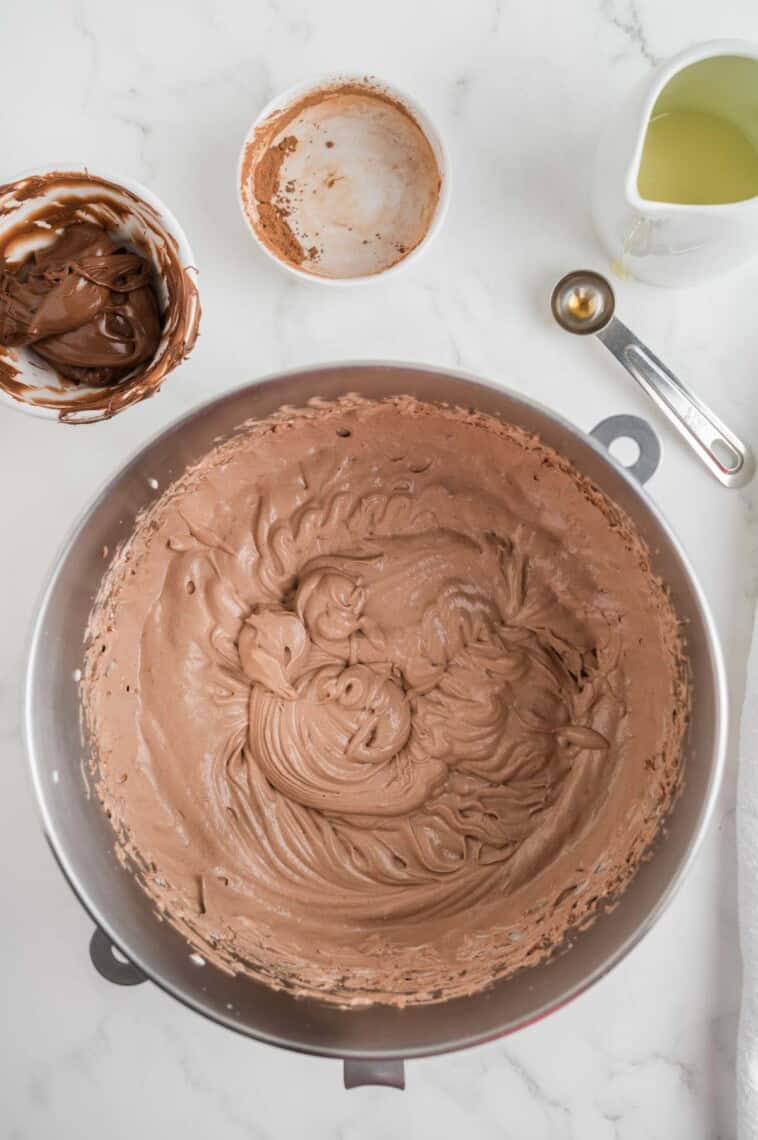 Ingredients for nutella ice cream are mixed together in a bowl.