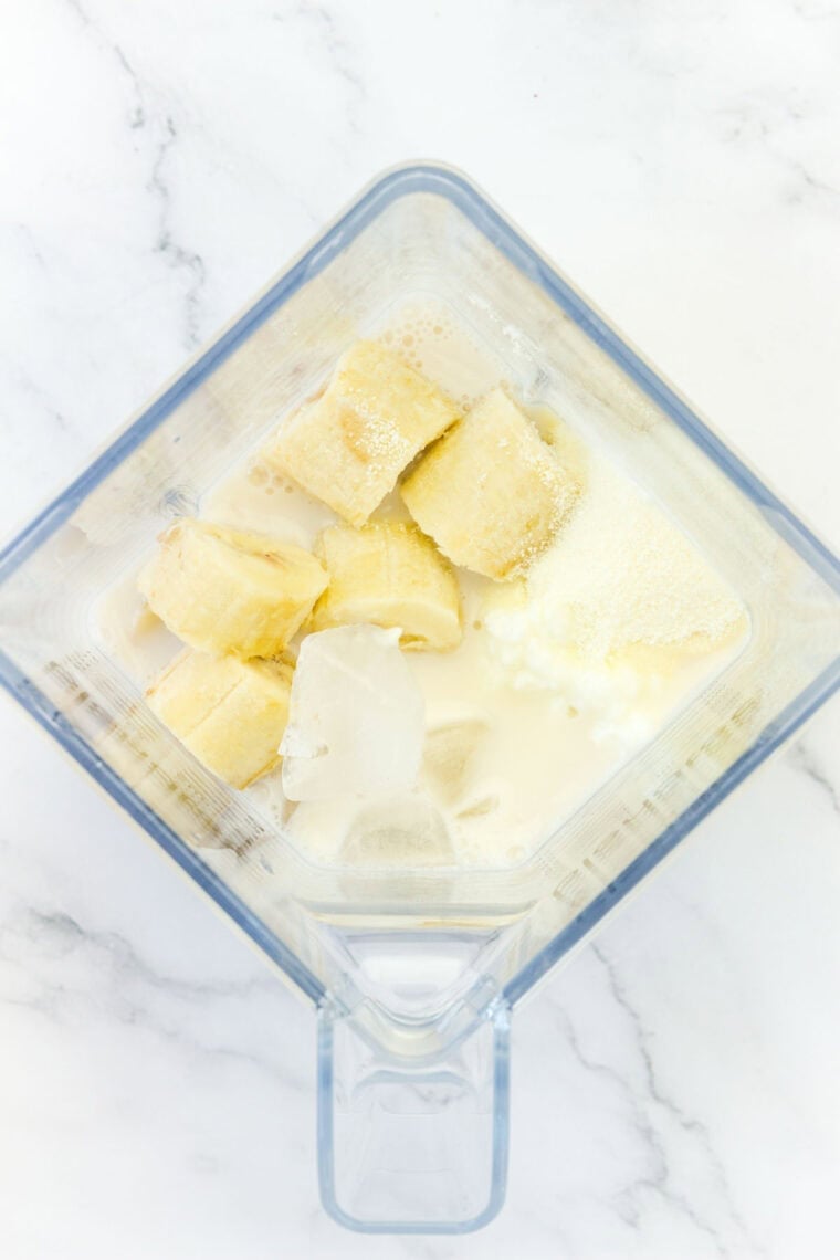 The banana smoothie ingredients are added to a blender.