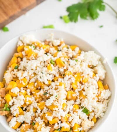 Fresh Mexican cheese tops a bowl of street corn salad.