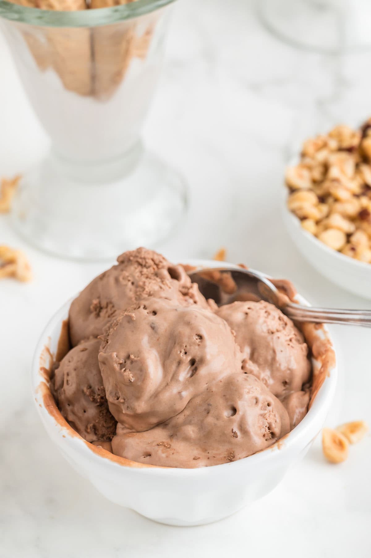 A bowl holds a big portion of chocolatey nutella ice cream.