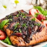 A piece of salmon topped with a strawberry balsamic glaze with text overlay that says "Strawberry Balsamic Salmon".