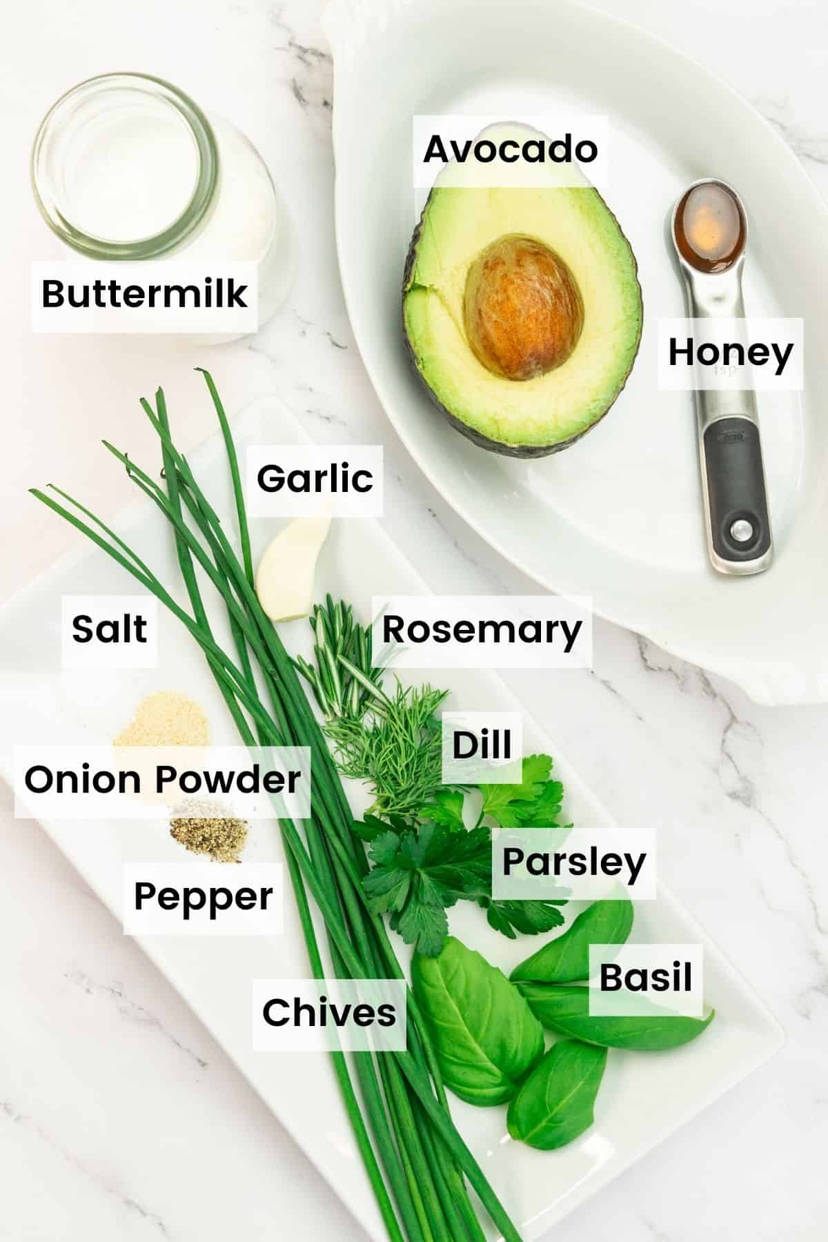 Ingredients for avocado ranch dressing: buttermilk, avocado, herbs, onion powder, honey, garlic, salt and pepper.