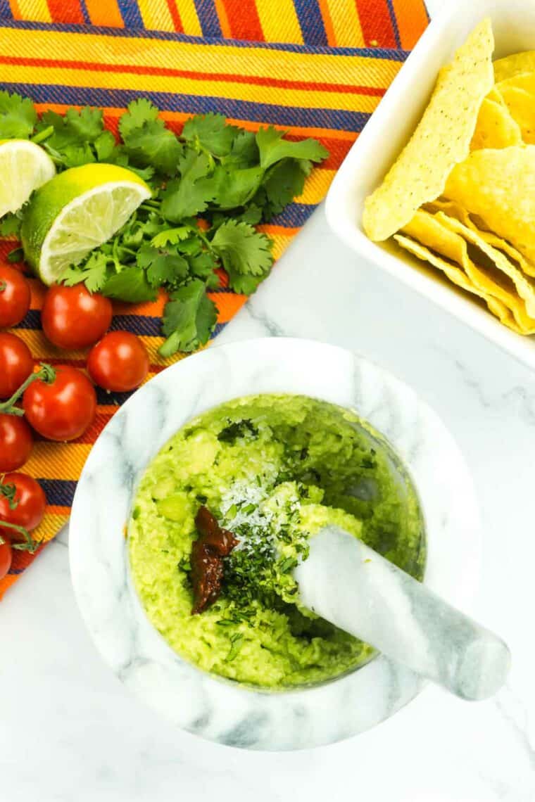 A pestle mixes the easy guacamole,