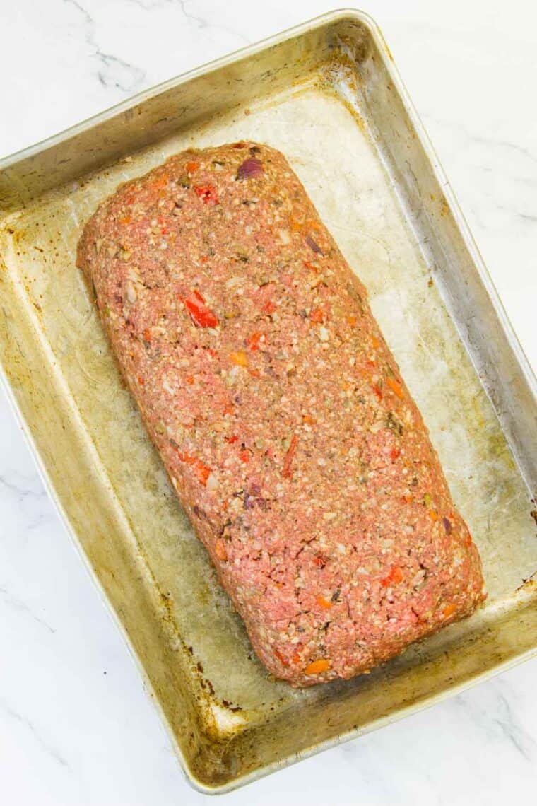 A formed meatloaf on a baking pan.