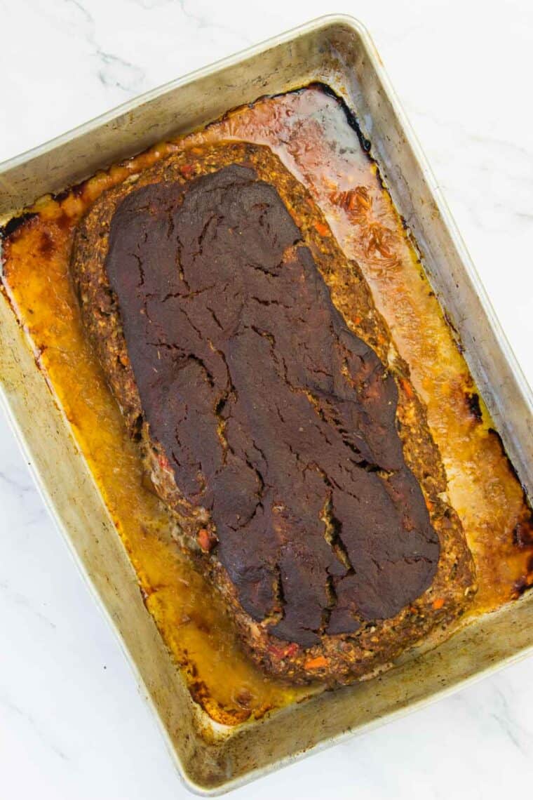 Balsamic ketchup is spread on meatloaf.