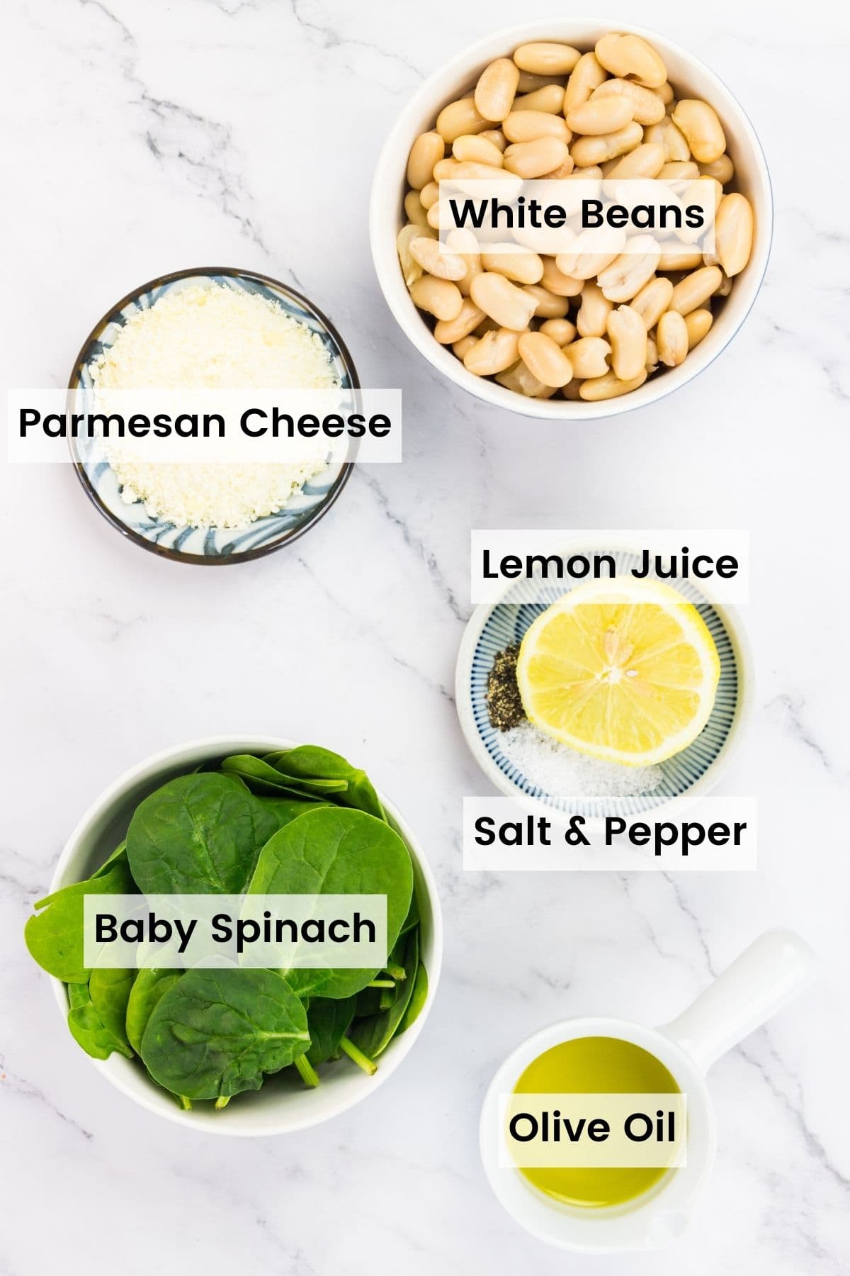 Labeled ingredients for parmesan white bean dip: parmesan cheese, olive oil, baby spinach, white beans, salt and pepper, lemon.