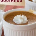 A pumpkin custard in a ramekin topped with whipped cream with text overlay that says "Pumpkin Custards".