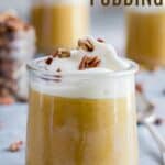 A jar of pale orange-colored pudding topped with whipped cream and nuts with text overlay that says "Pumpkin Pudding".