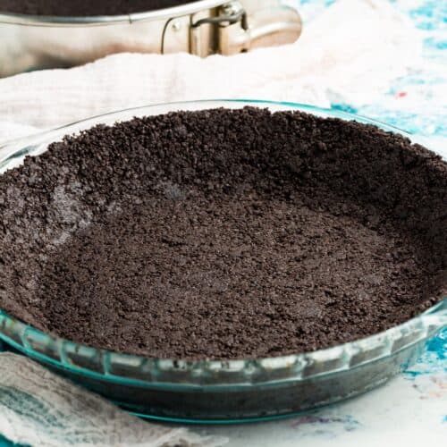 A glass pie pan with a gluten free oreo cookie crust,