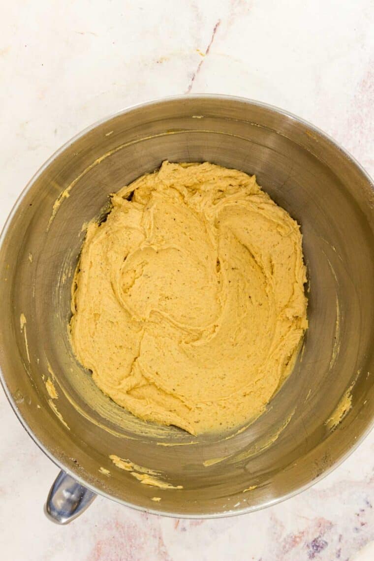 Pumpkin frosting in a metal bowl.