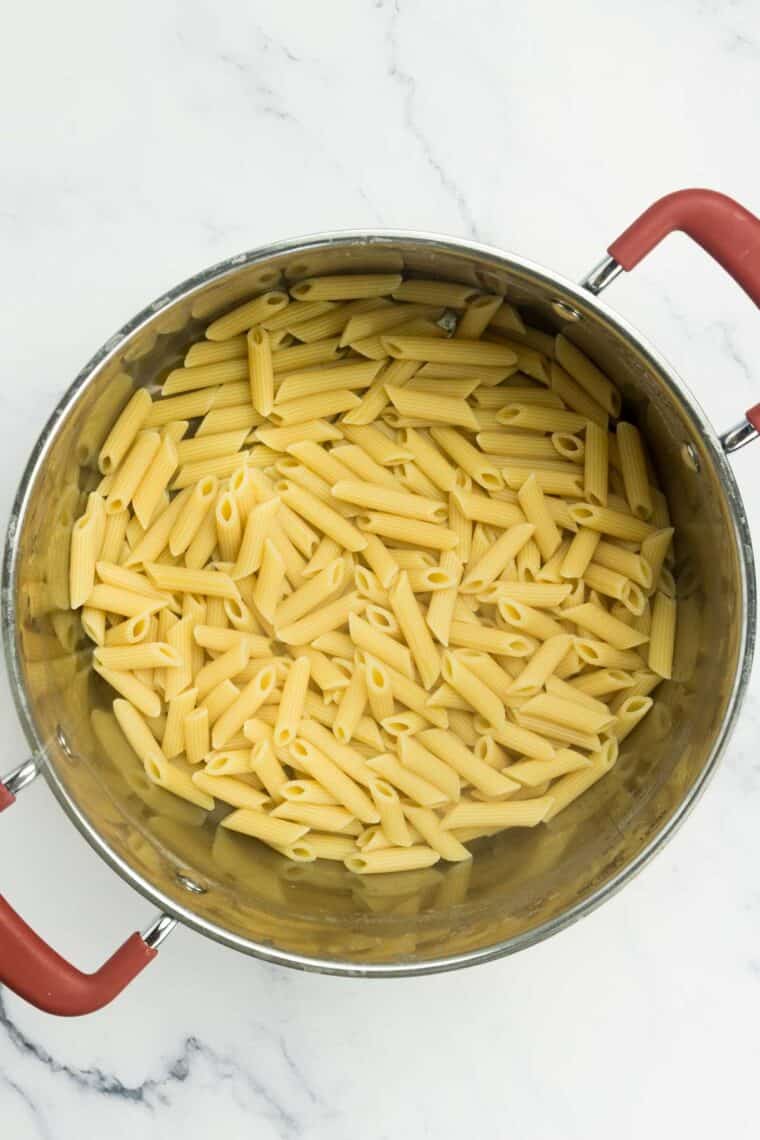 Cooked penne pasta in a pot.