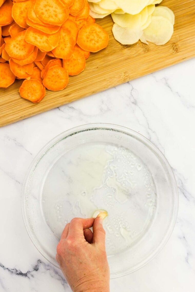 Greasing a clear baking dish.