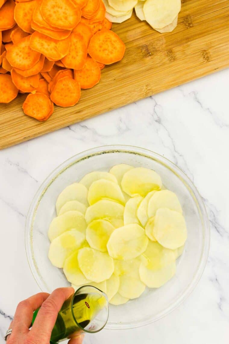 White potato slices arranged in a baking dish.