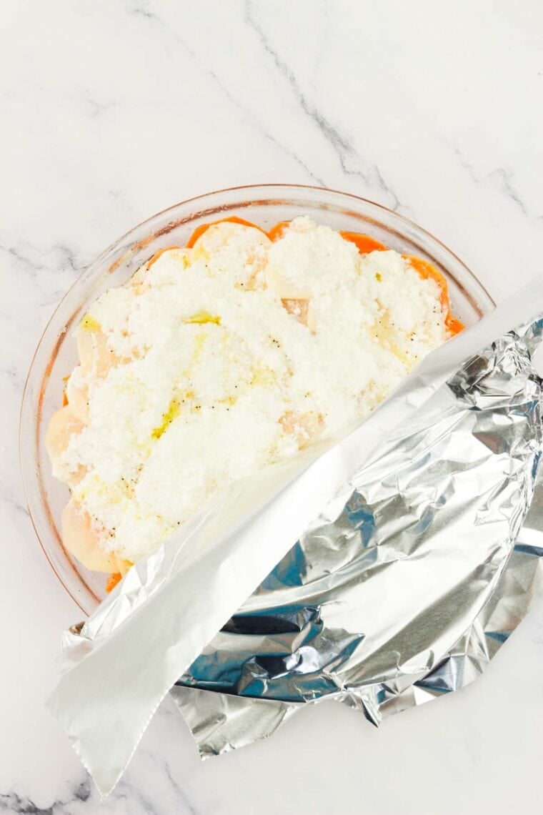 Foil covers a pan of sweet potato gratin.