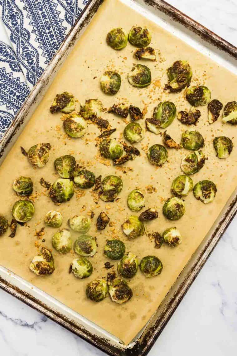 Brussels sprouts on a baking sheet after being roasted.