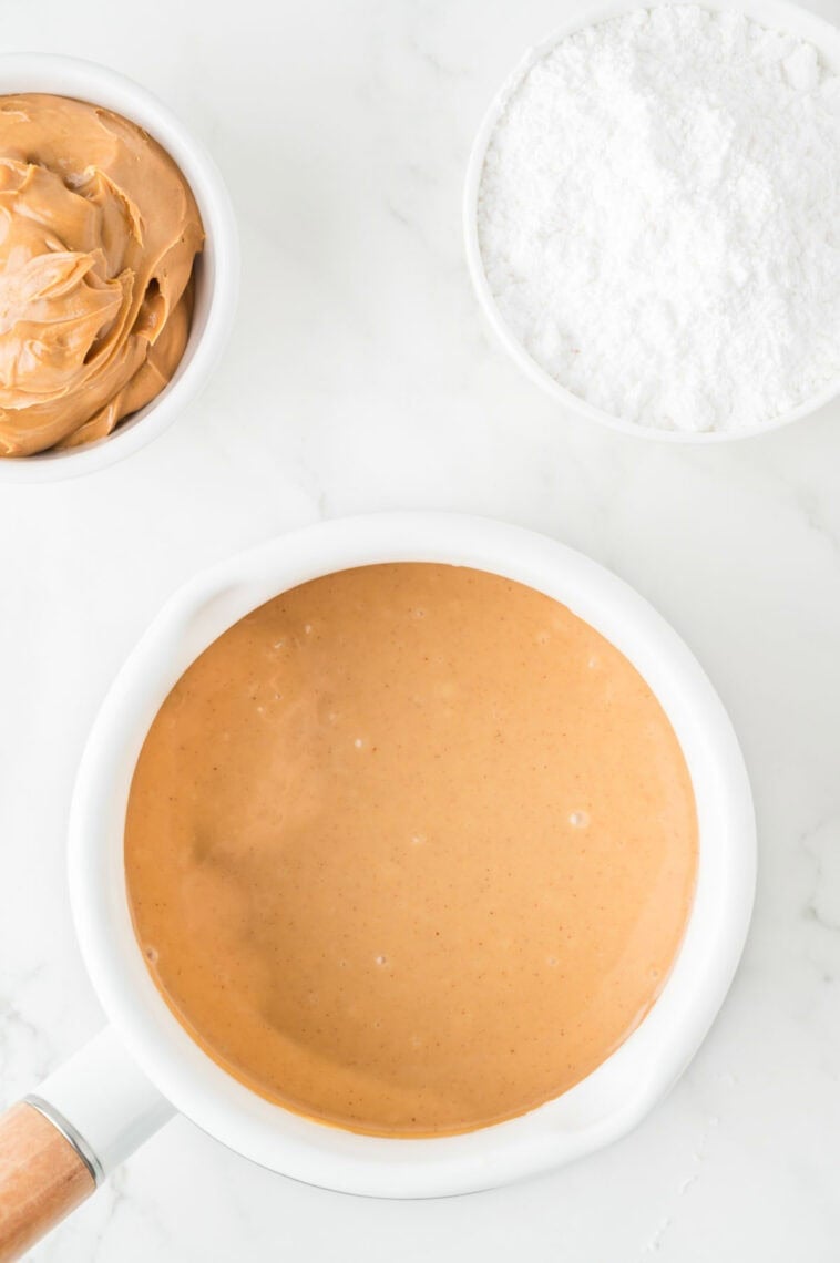 The peanut-milk mixture melts in a pot.