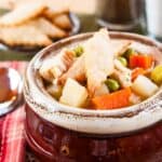 Pie crust crust crackers on the top of a bowl of turkey pot pie soup.