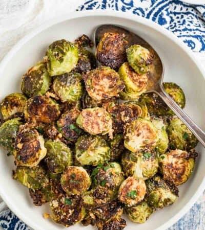 A white serving bowl of Garlic Parmesan Roasted Brussels Sprouts.