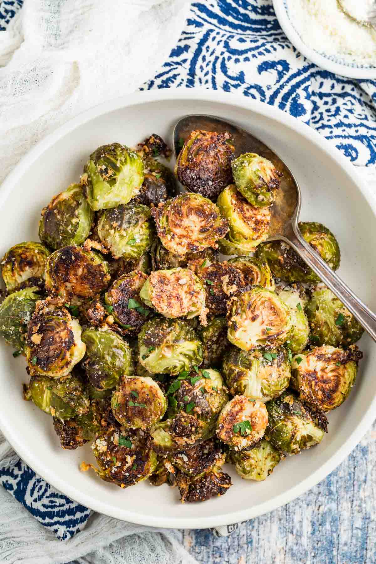 A white serving bowl of Garlic Parmesan Roasted Brussels Sprouts.