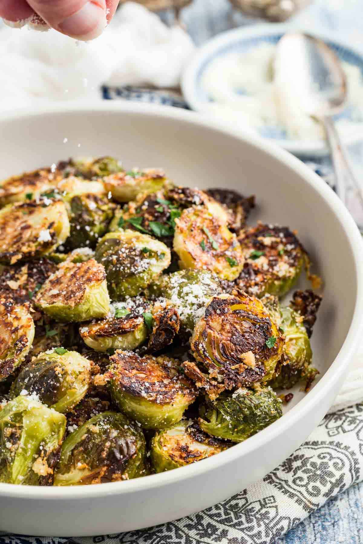 Crispy roasted Brussels sprouts with parmesan in a bowl.