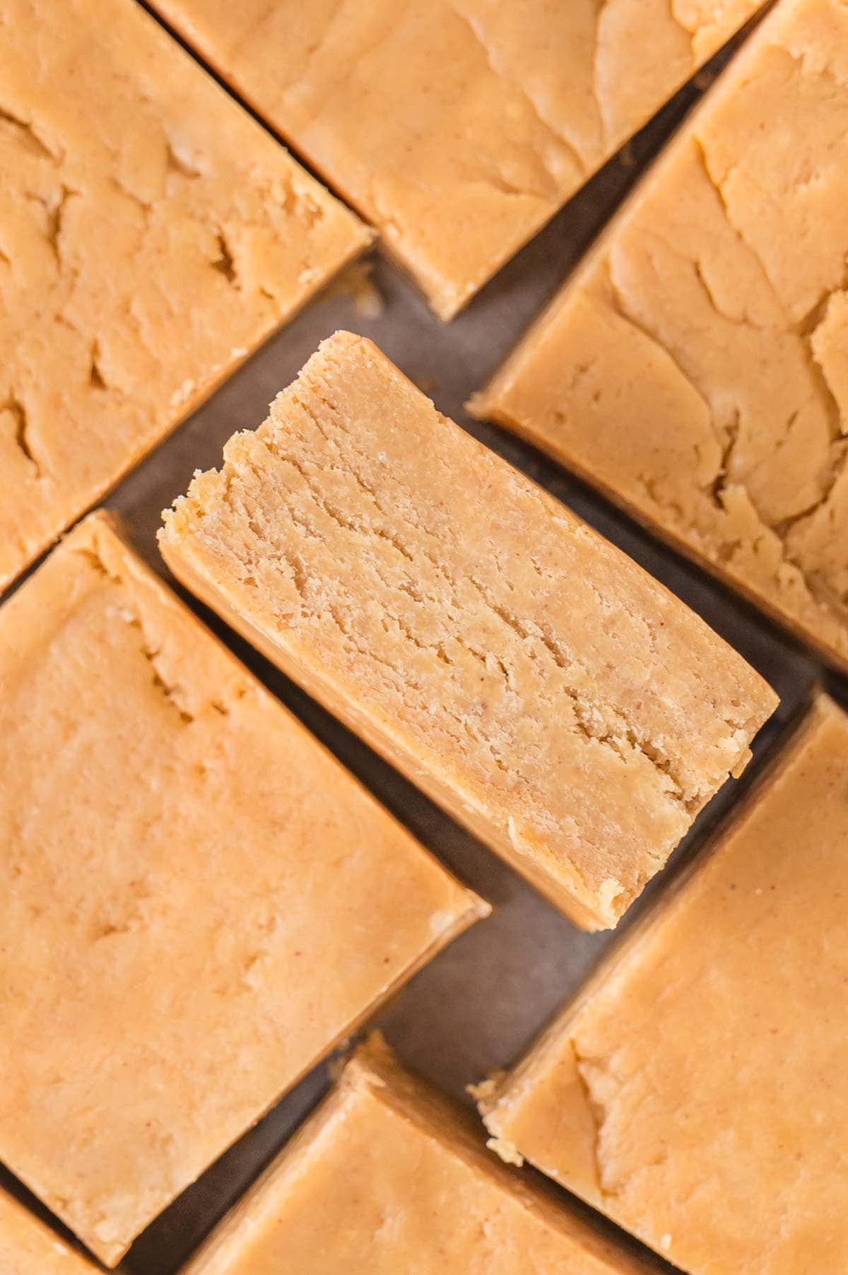 Squares of peanut butter fudge next to each other.