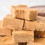 A pile of pieces of peanut butter fudge with a bite out of the top one.