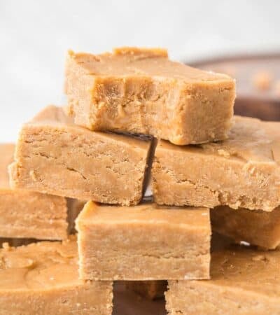 A pile of pieces of peanut butter fudge with a bite out of the top one.