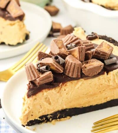 Chopped peanut butter cups top a slice of peanut butter pie.