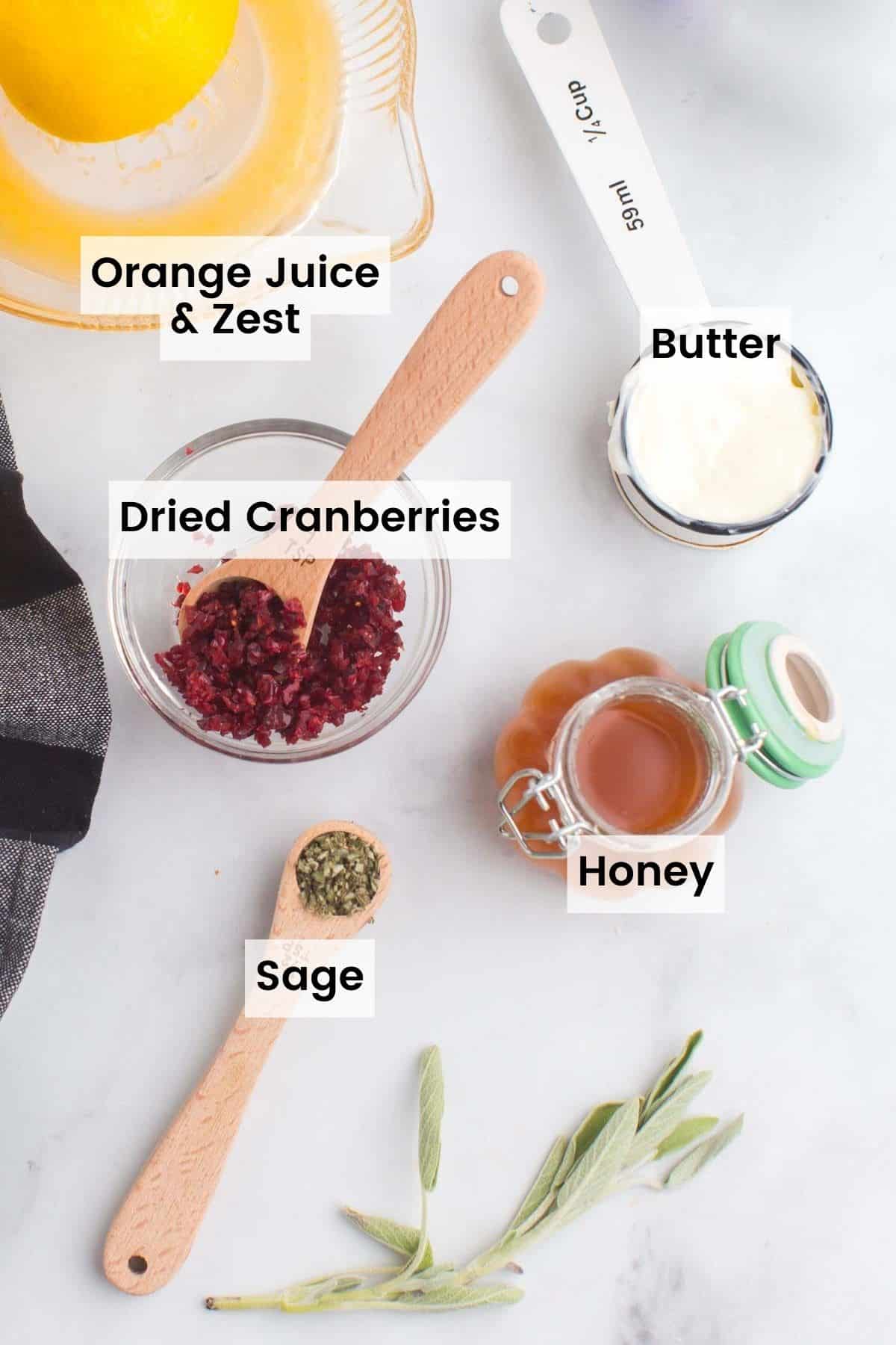 Ingredients to make compound butter portioned out on a countertop with text labels.