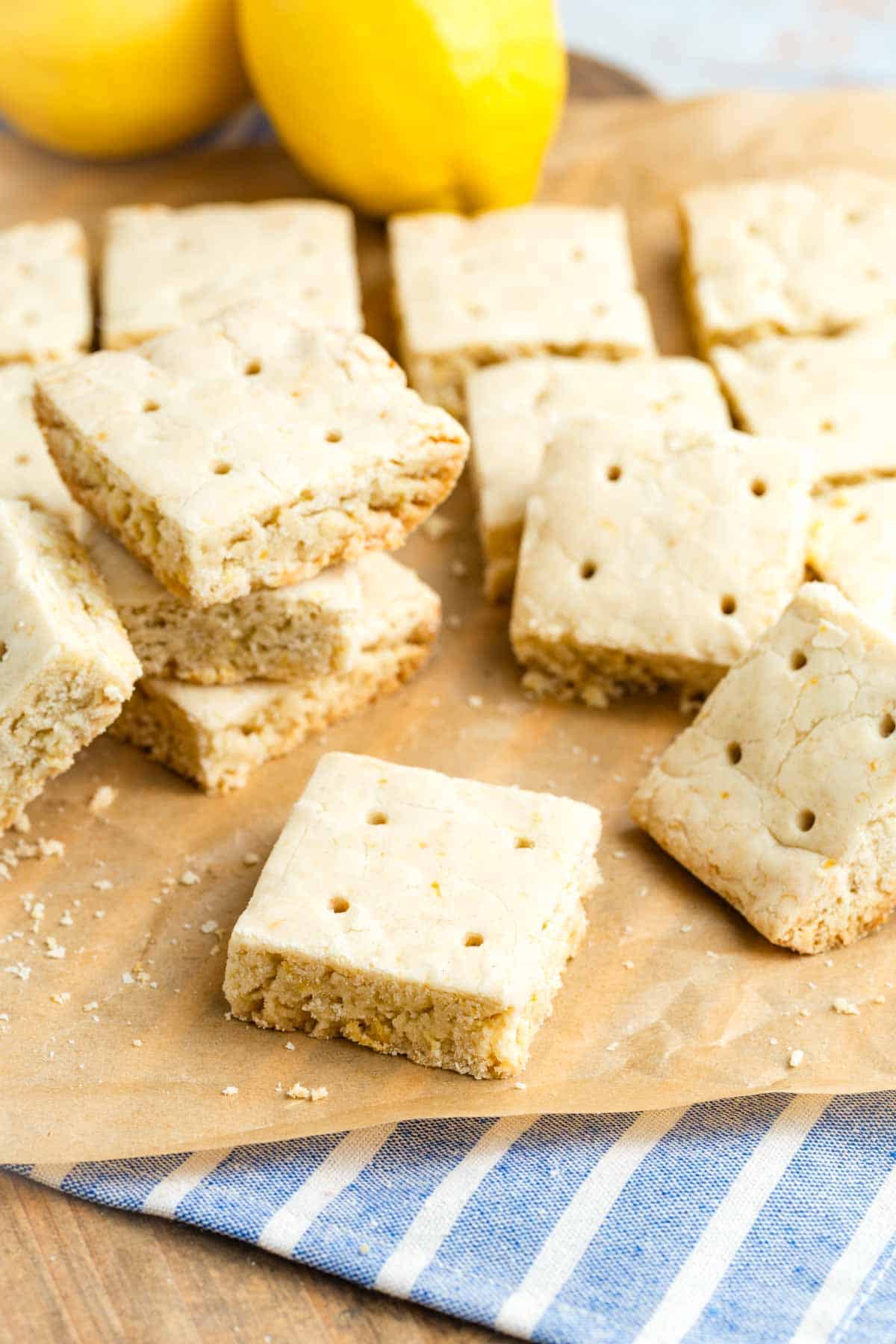 Squares of lemon shortbread cookies on a counter.