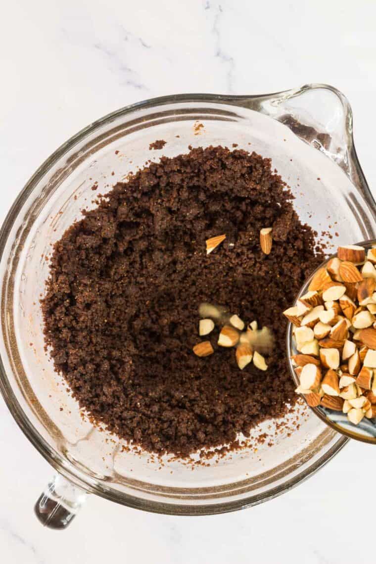 Chopped almonds are added to chocolate almond cookie dough.