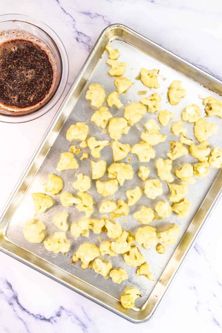 Baked battered cauliflower on a sheet pan.