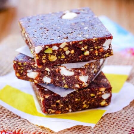 Three cherry energy bars stacked on top of each other.