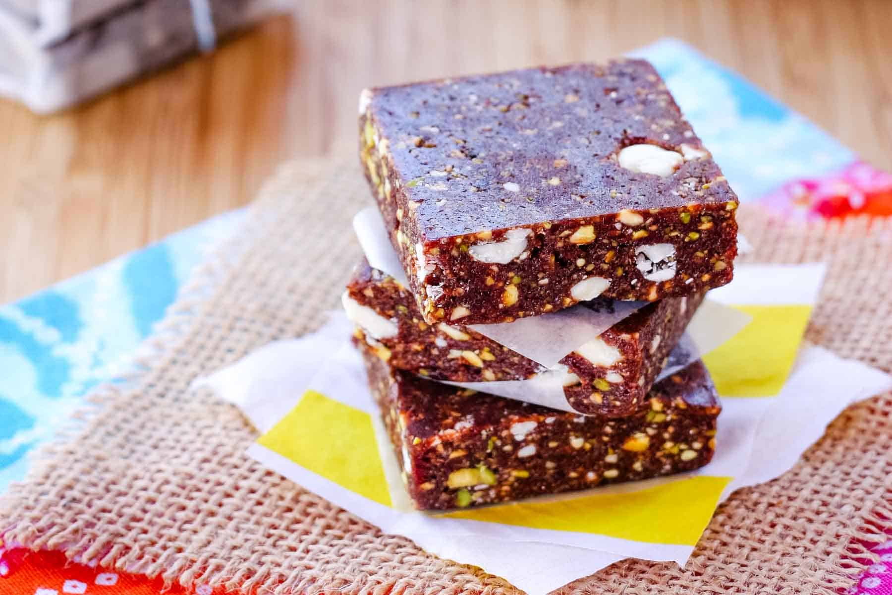 Three cherry energy bars stacked on top of each other.