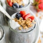 Granola and berries top a jar of chia seed pudding.