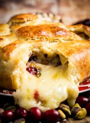 Melted cheese spills out of crescent dough.