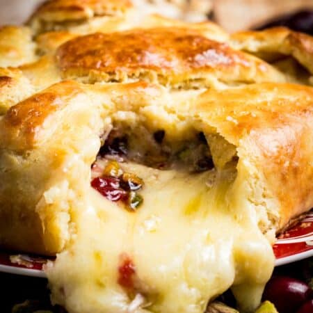 Melted cheese spills out of crescent dough.