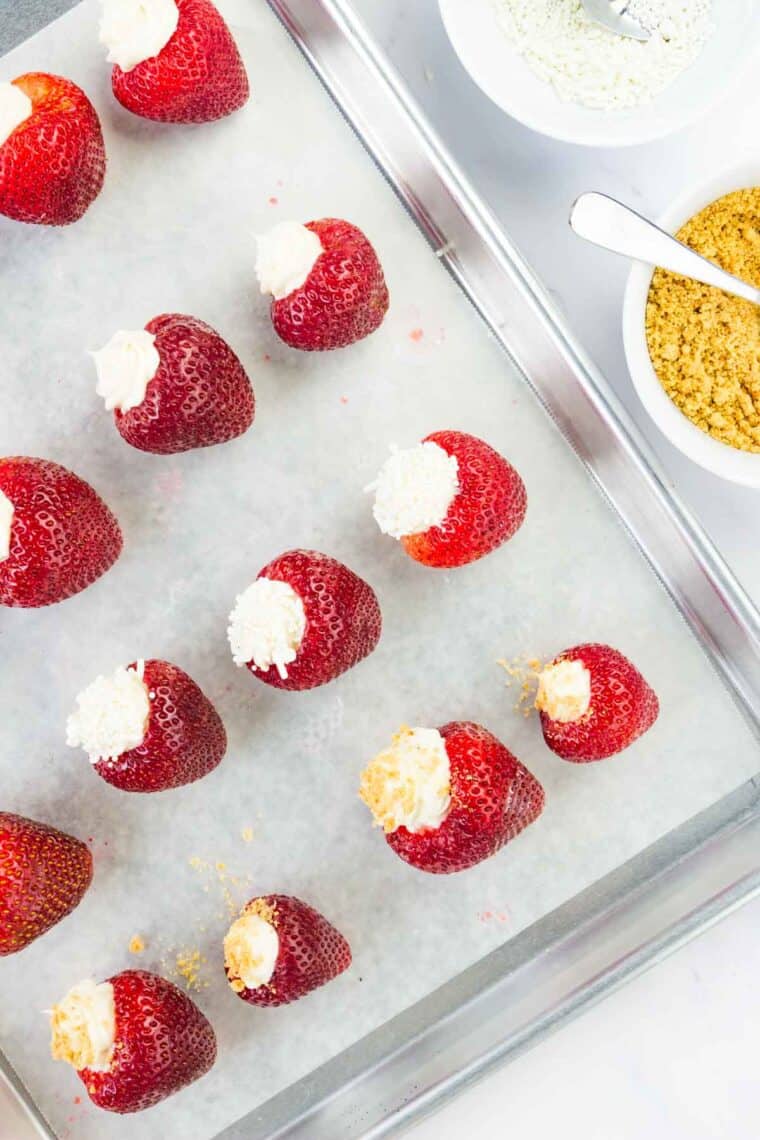 A tray of cheesecake stuffed strawberries.