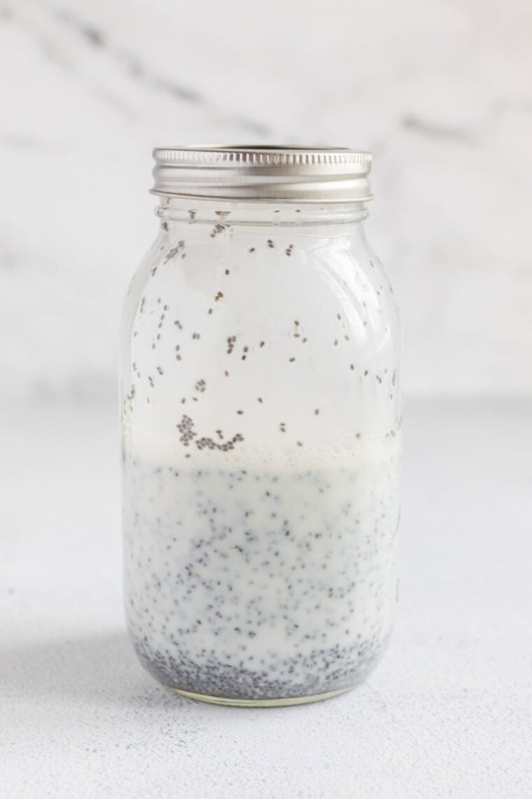 Milk and chia seeds are shaken together in a jar.